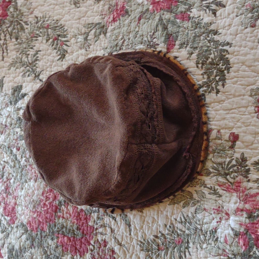 Reversible cloth hat. One side is brown the other is animal print.